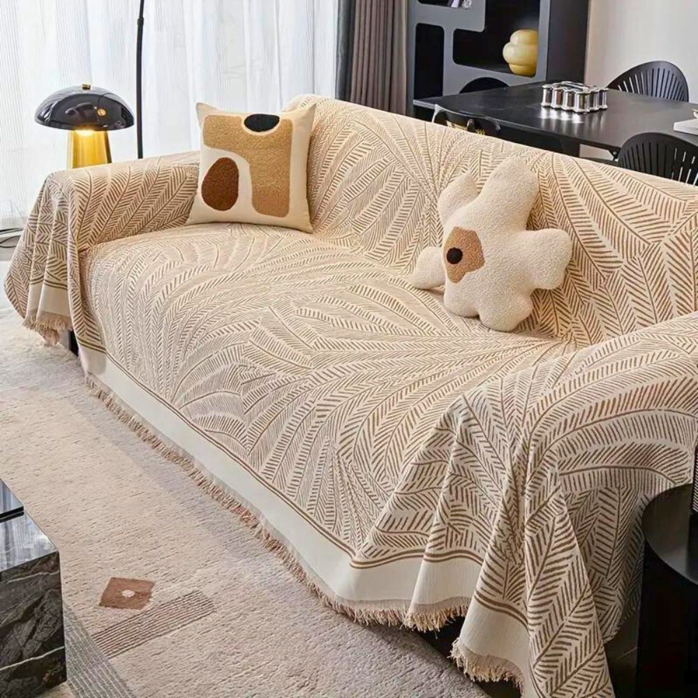 https://cdn.shopify.com/s/files/1/0737/4166/4542/files/LeafPatternLuxurySofaCover_1.jpg?v=1743935285